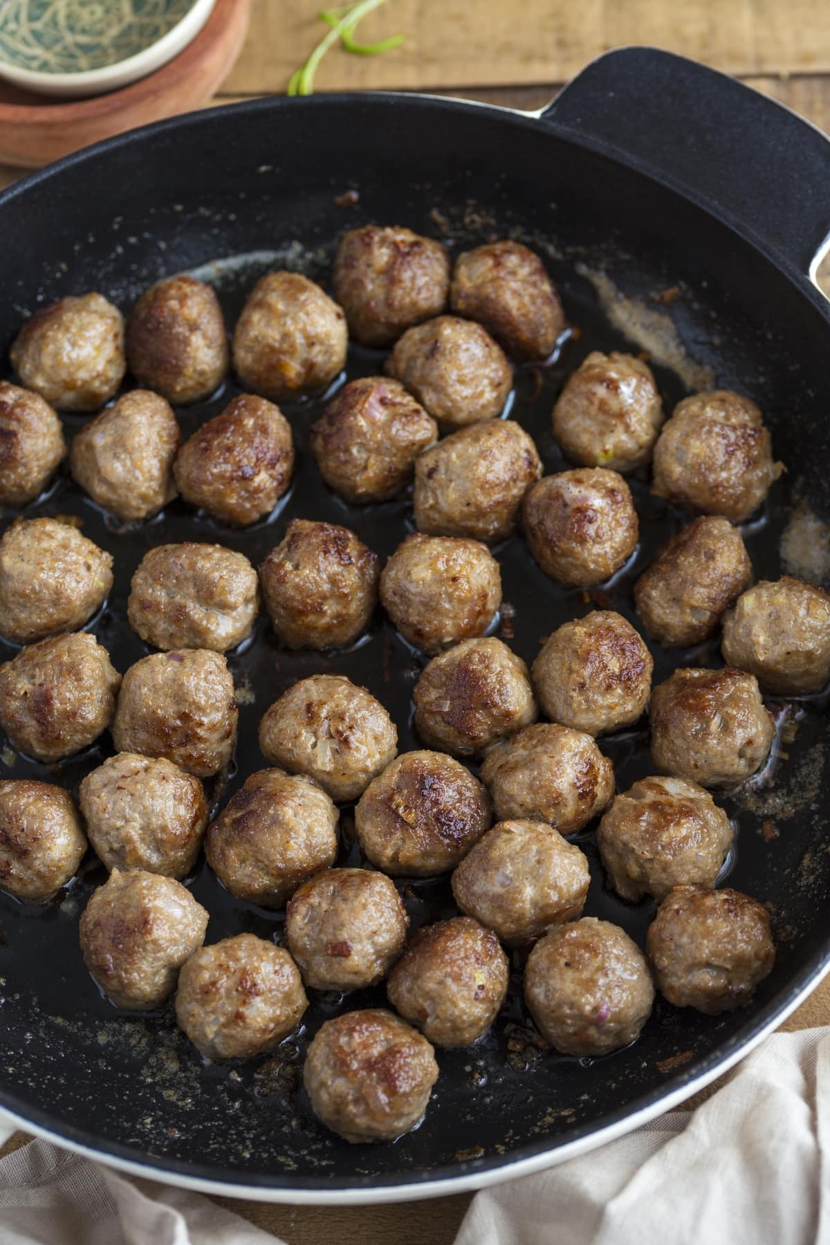 Frying meatballs in a skillet.