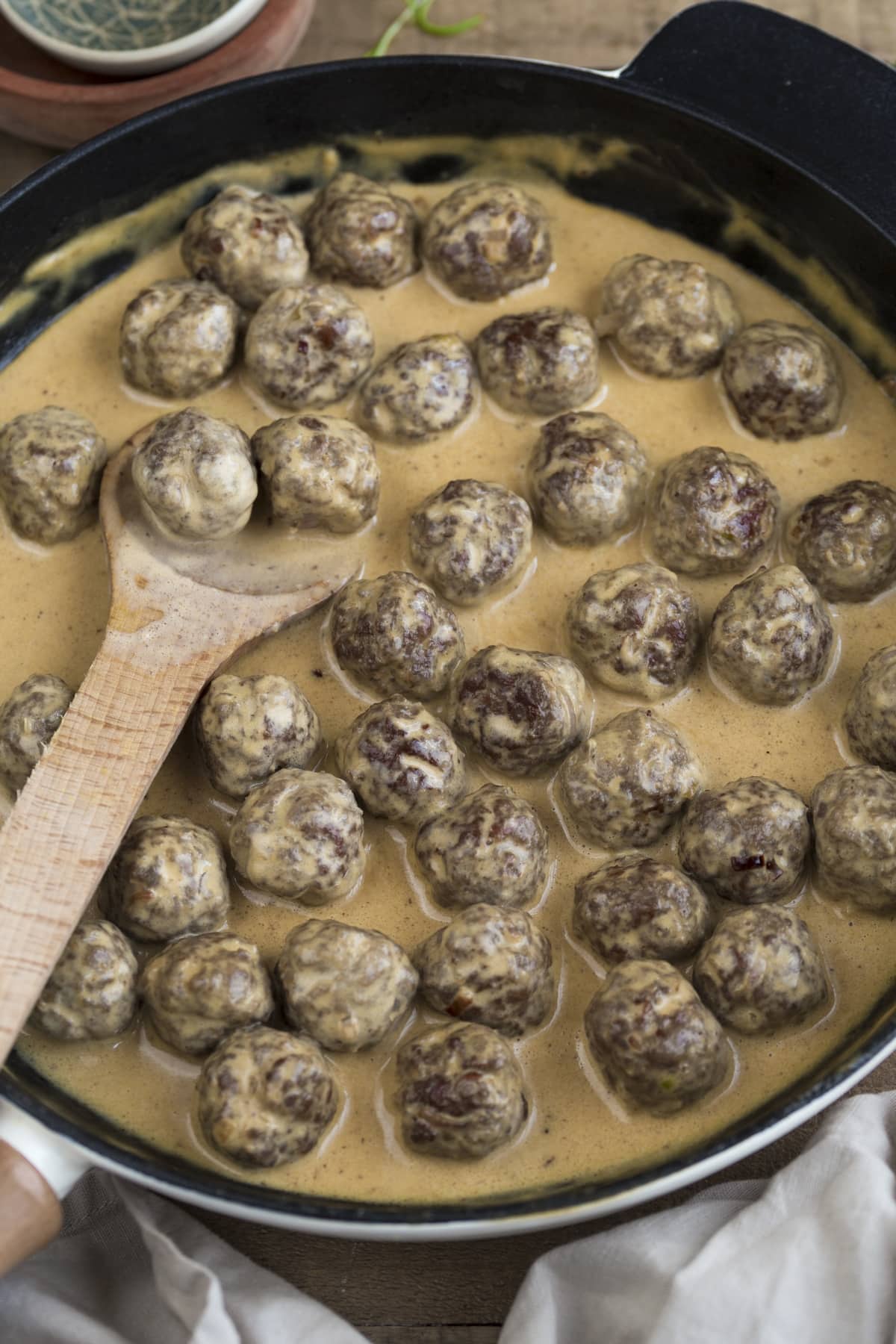 Swedish meatballs in cream sauce in a skillet.