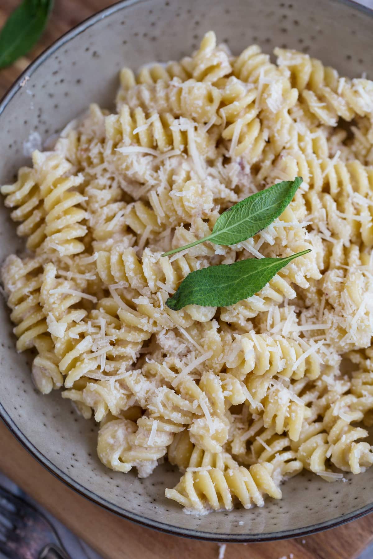 Walnut sauce pasta topped with two sage leaves.