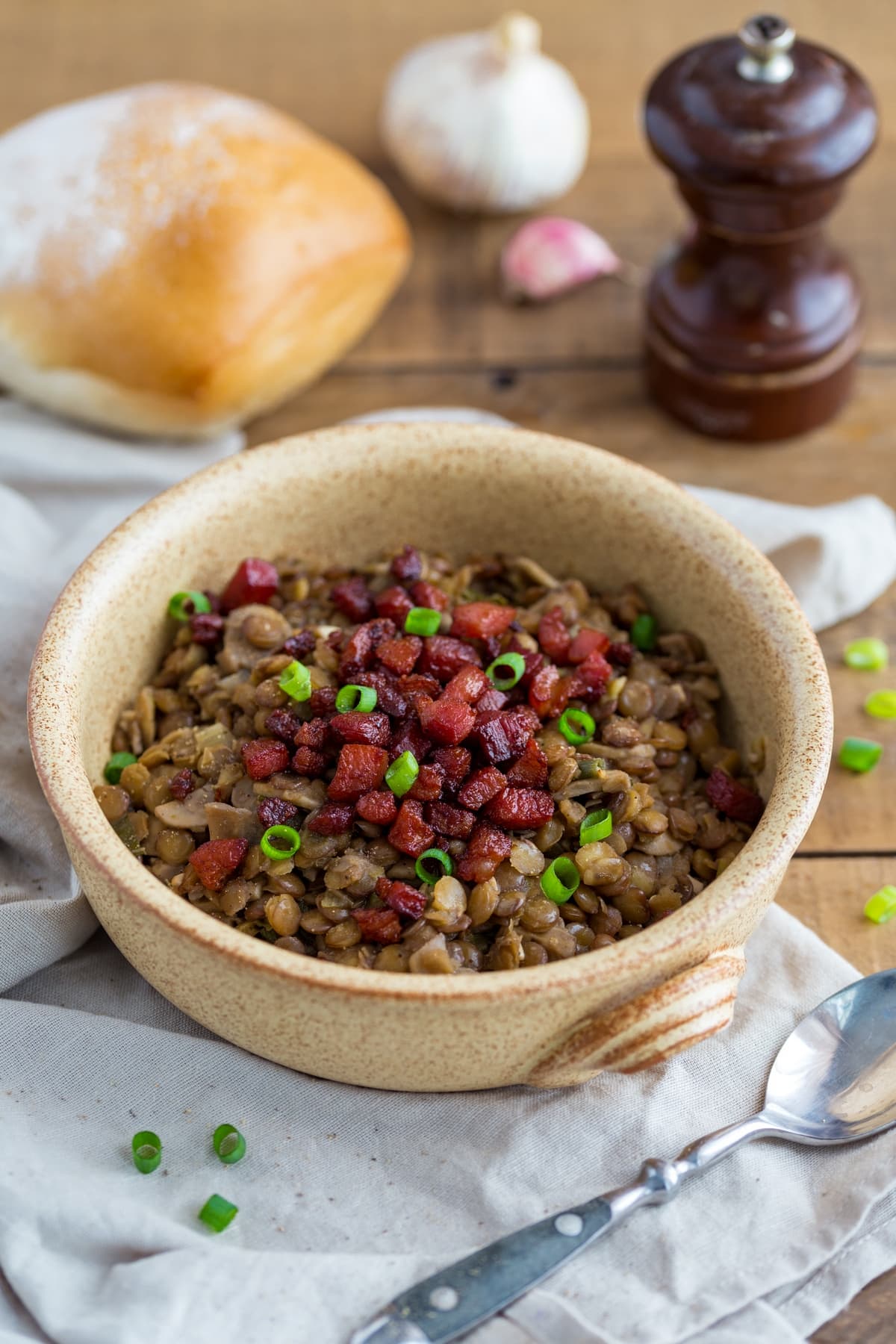 Italian lentil stew plated in a stoneware bowl.