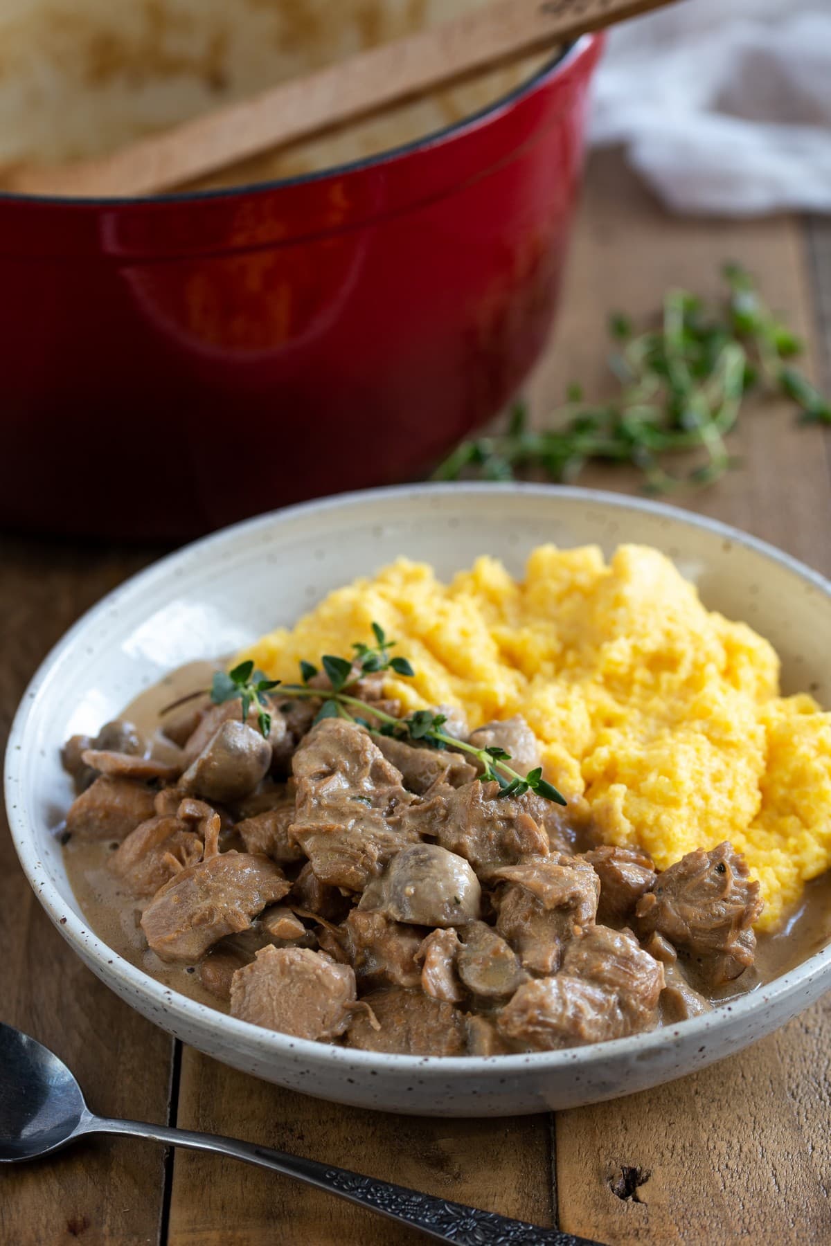 Cream cheese chicken served with a side of polenta.