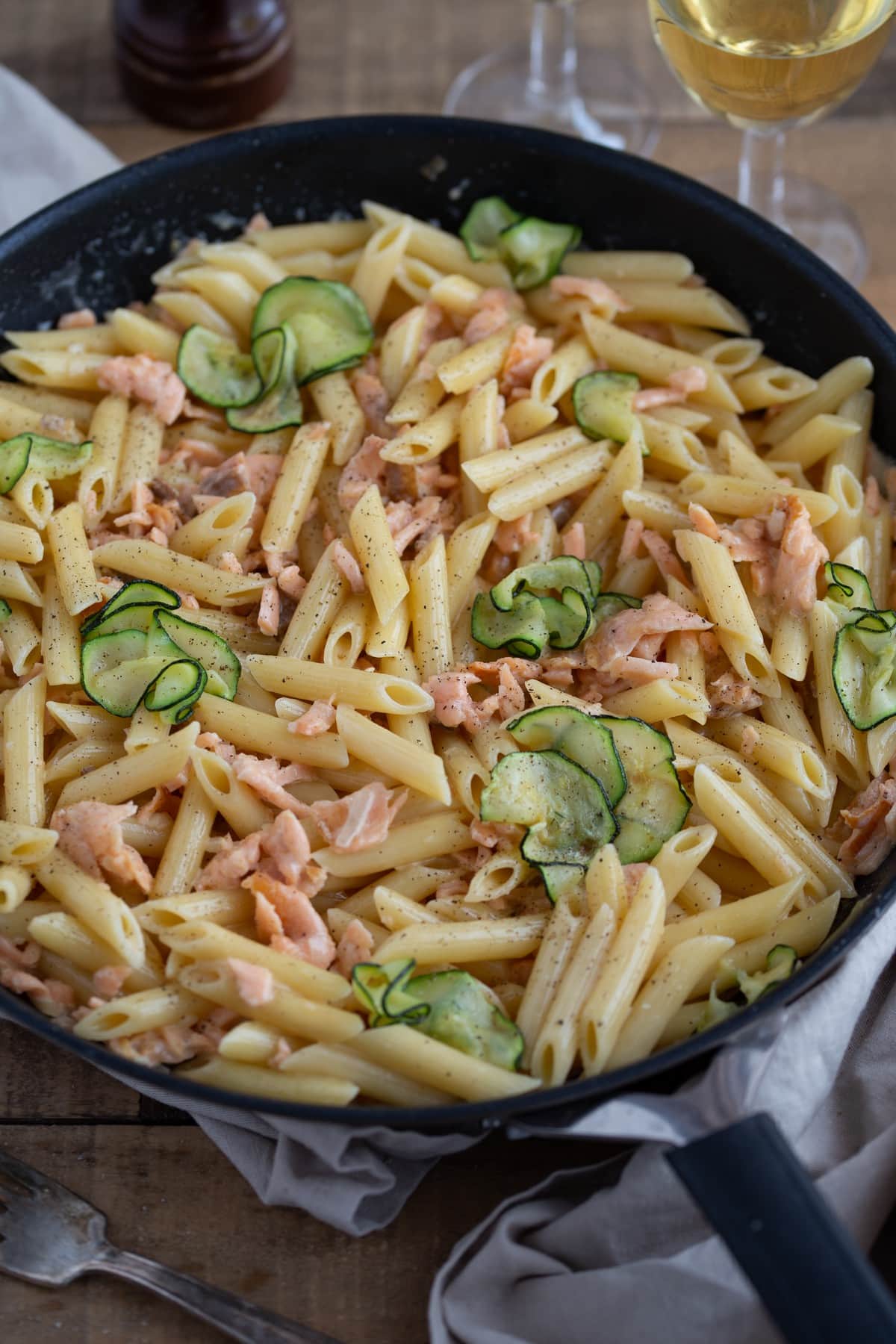 Salmon pasta in creamy vodka sauce in a skillet.