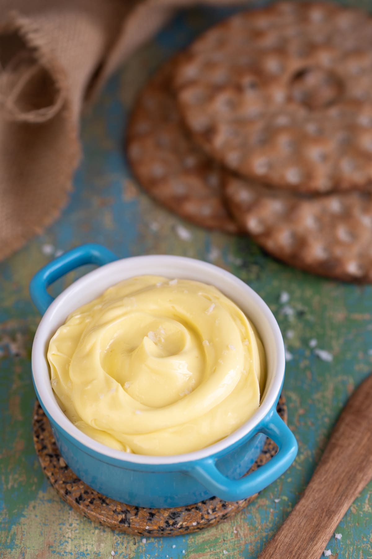 Homemade olive oil butter spread next to crispbread slices.