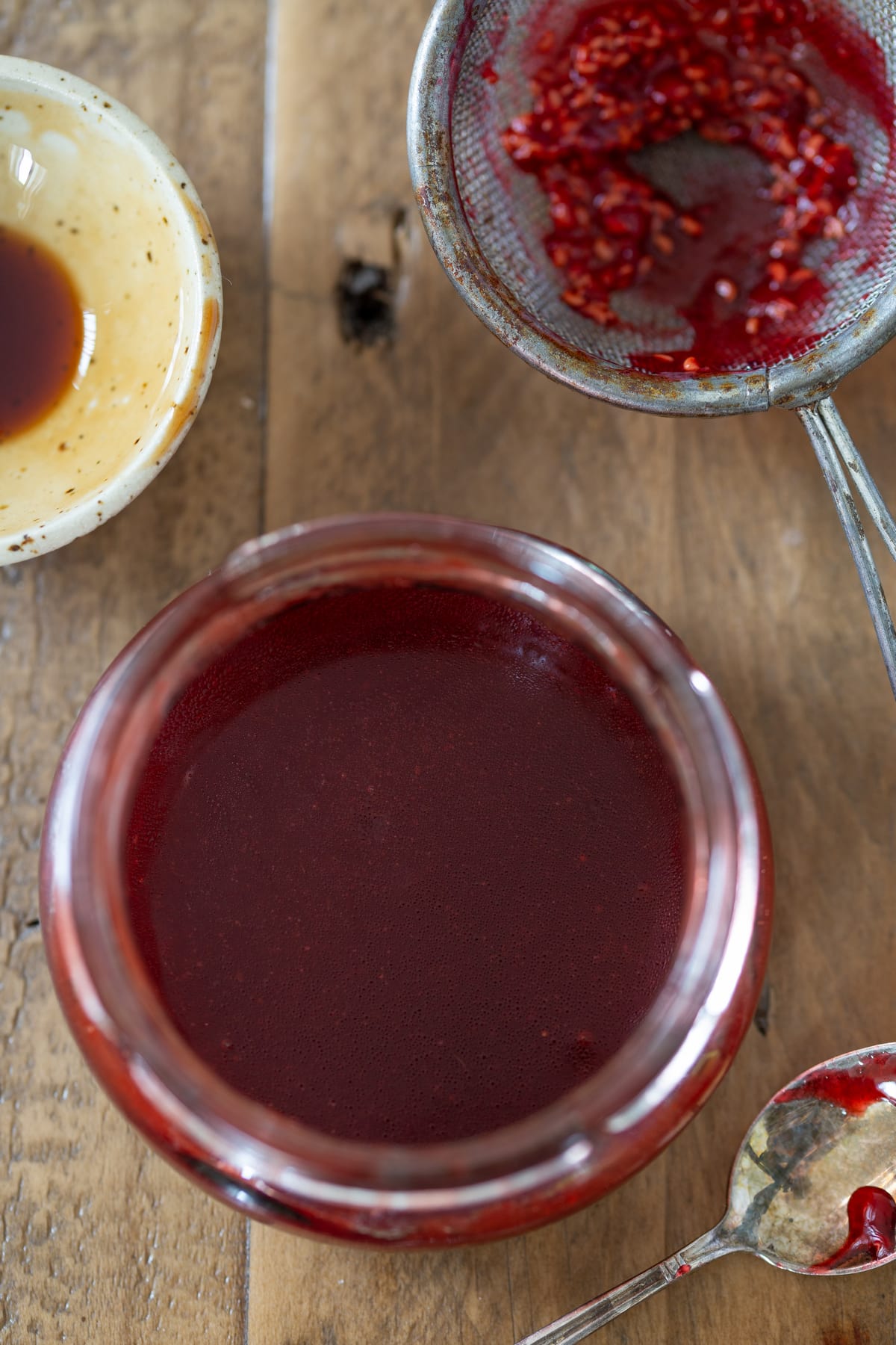 Raspberry balsamico dressing in a small jar after emulsifying.