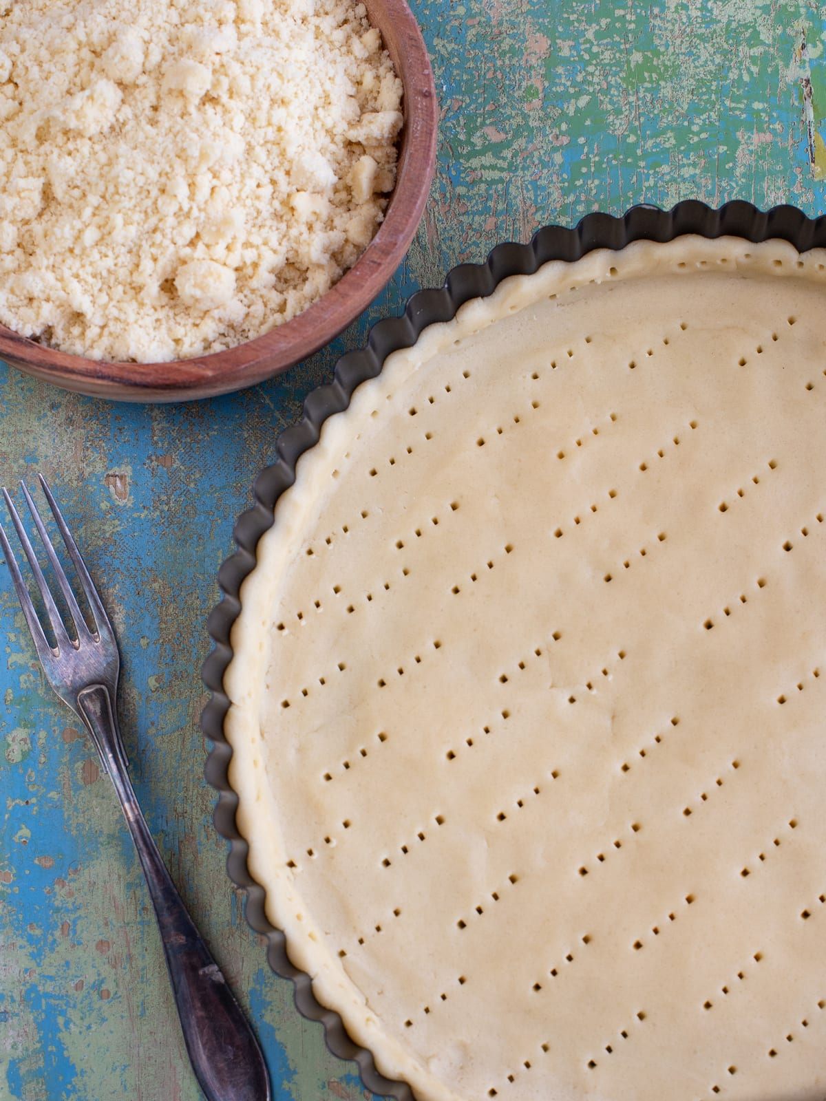 Shortcrust pastry pressed into a tart tin and pricked with a fork.