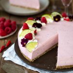 Pink cheesecake with a slice missing.