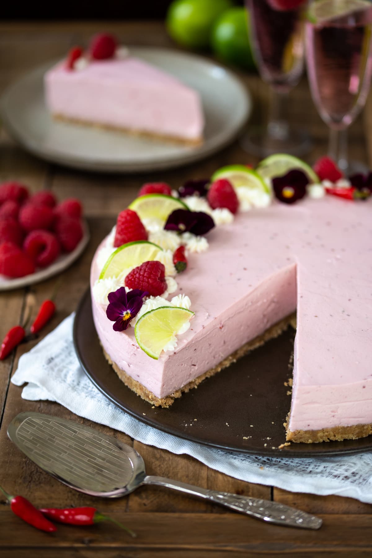 Pink cheesecake with a slice missing.