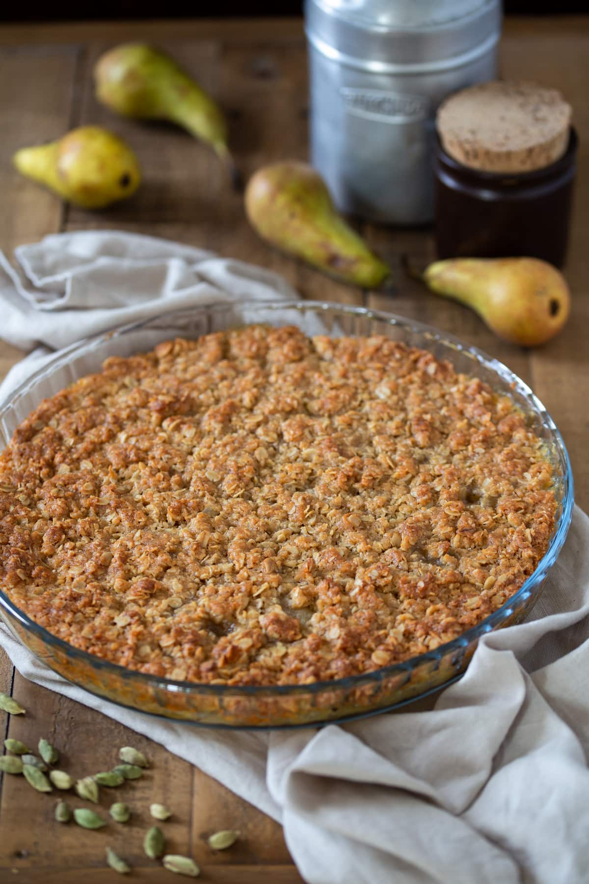 Whole pear crisp in a see-through pan.