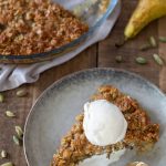 A slice of maple oat crisp with vanilla ice cream.