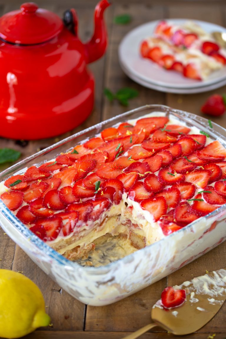 Strawberry limoncello tiramisu with one portion missing.