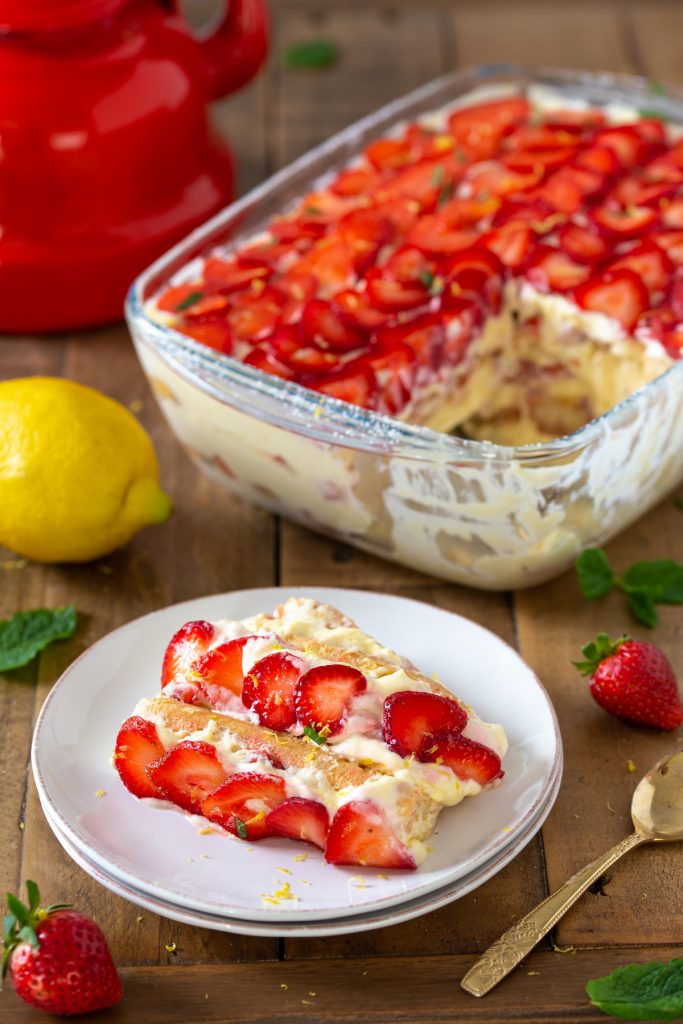 A portion of strawberry tiramisu on a white plate.