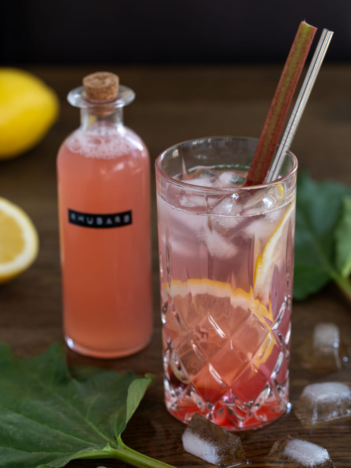 Rhubarb G&T next to a bottle of rhubarb syrup.