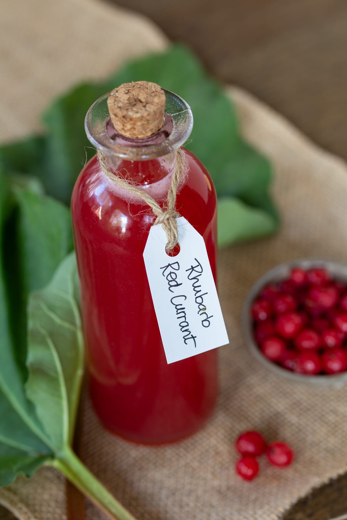 A small bottle of rhubarb and redcurrant syrup.