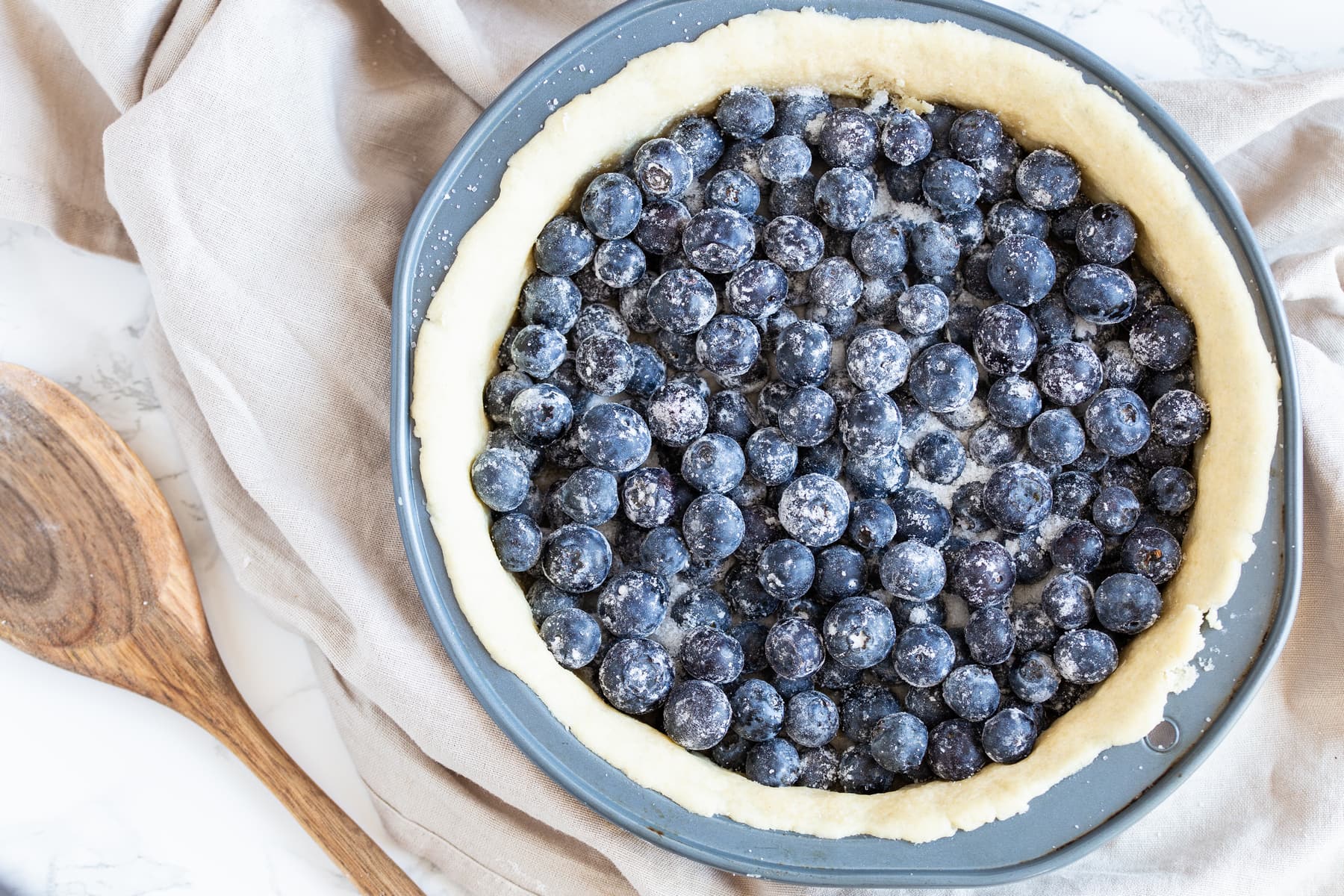 Adding blueberries to pre-baked shortcrust.