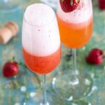 Strawberry rhubarb bellini with a fresh strawberry on top.
