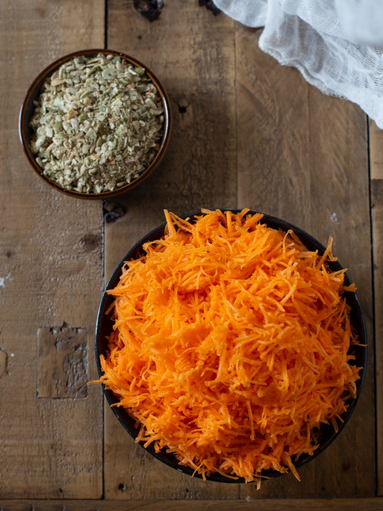 Grated carrots and crushed seeds.