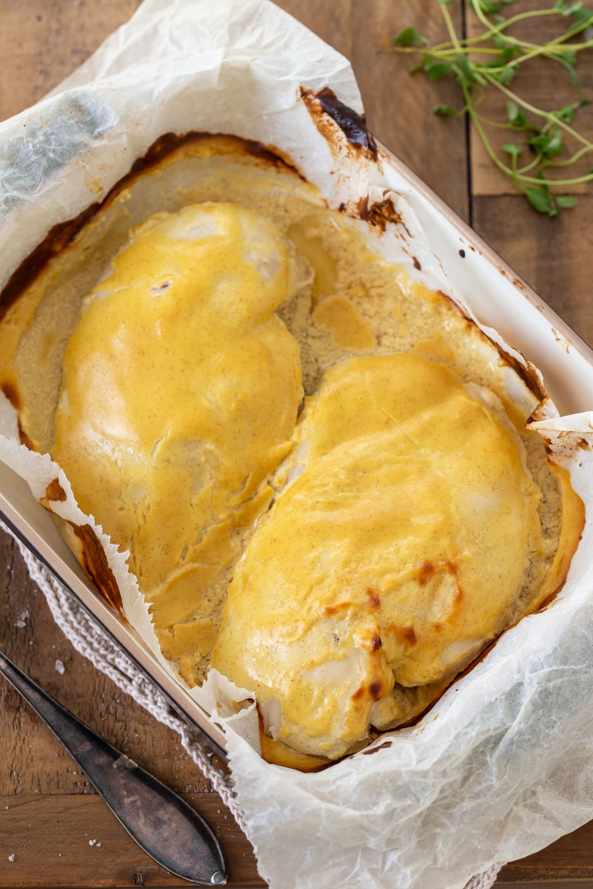 Baked mustard chicken in a casserole dish.