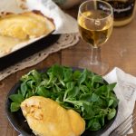 A single chicken breast baked with mustard.