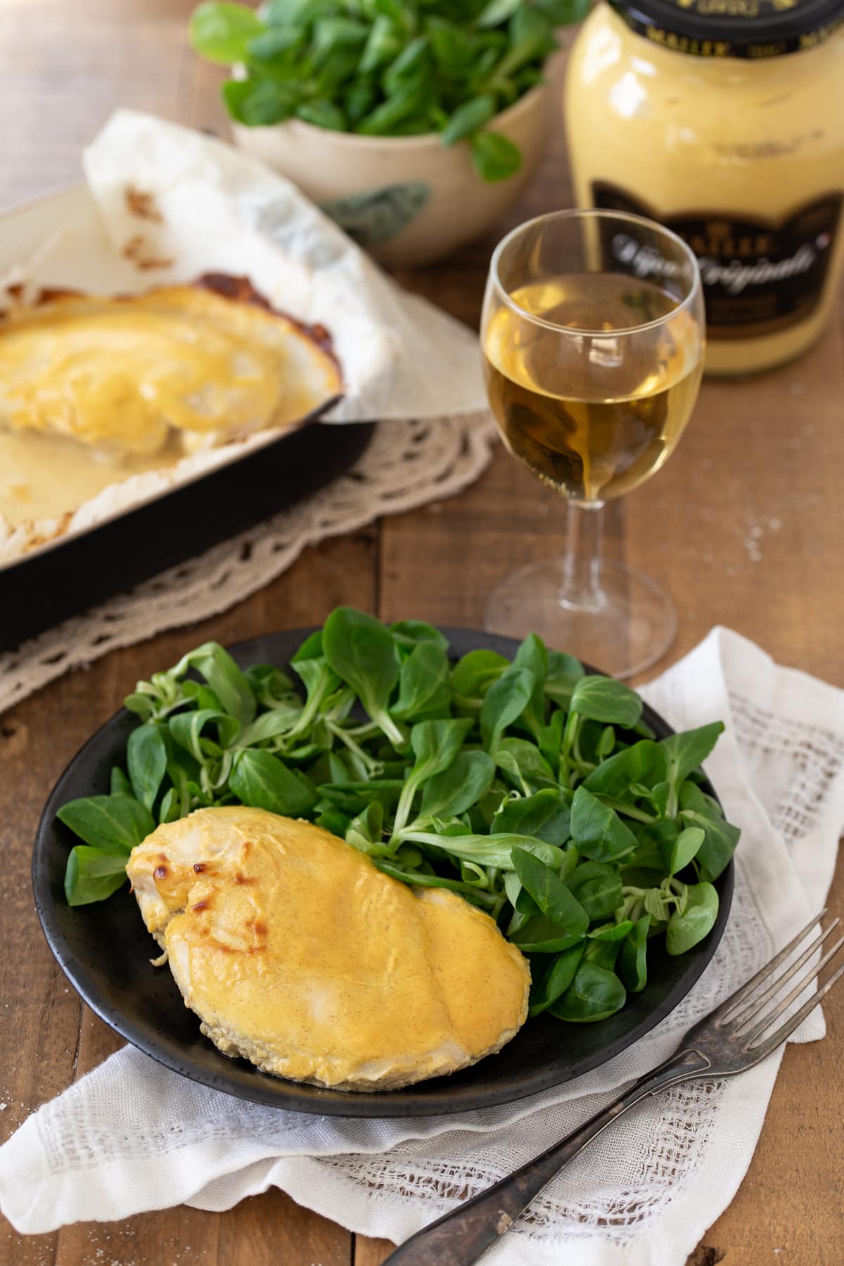 A single chicken breast served with salad.