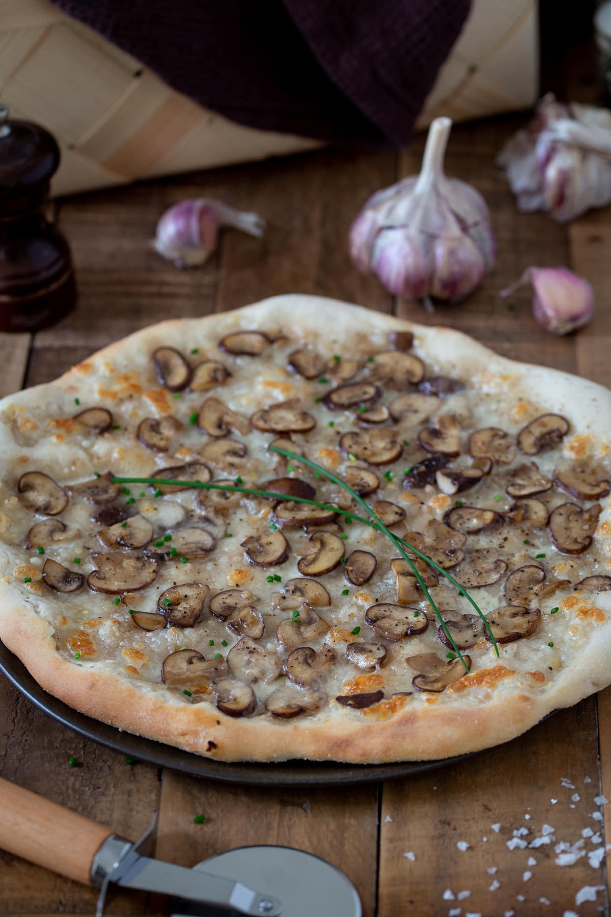 Garlic mushroom pizza garnished with fresh chives.