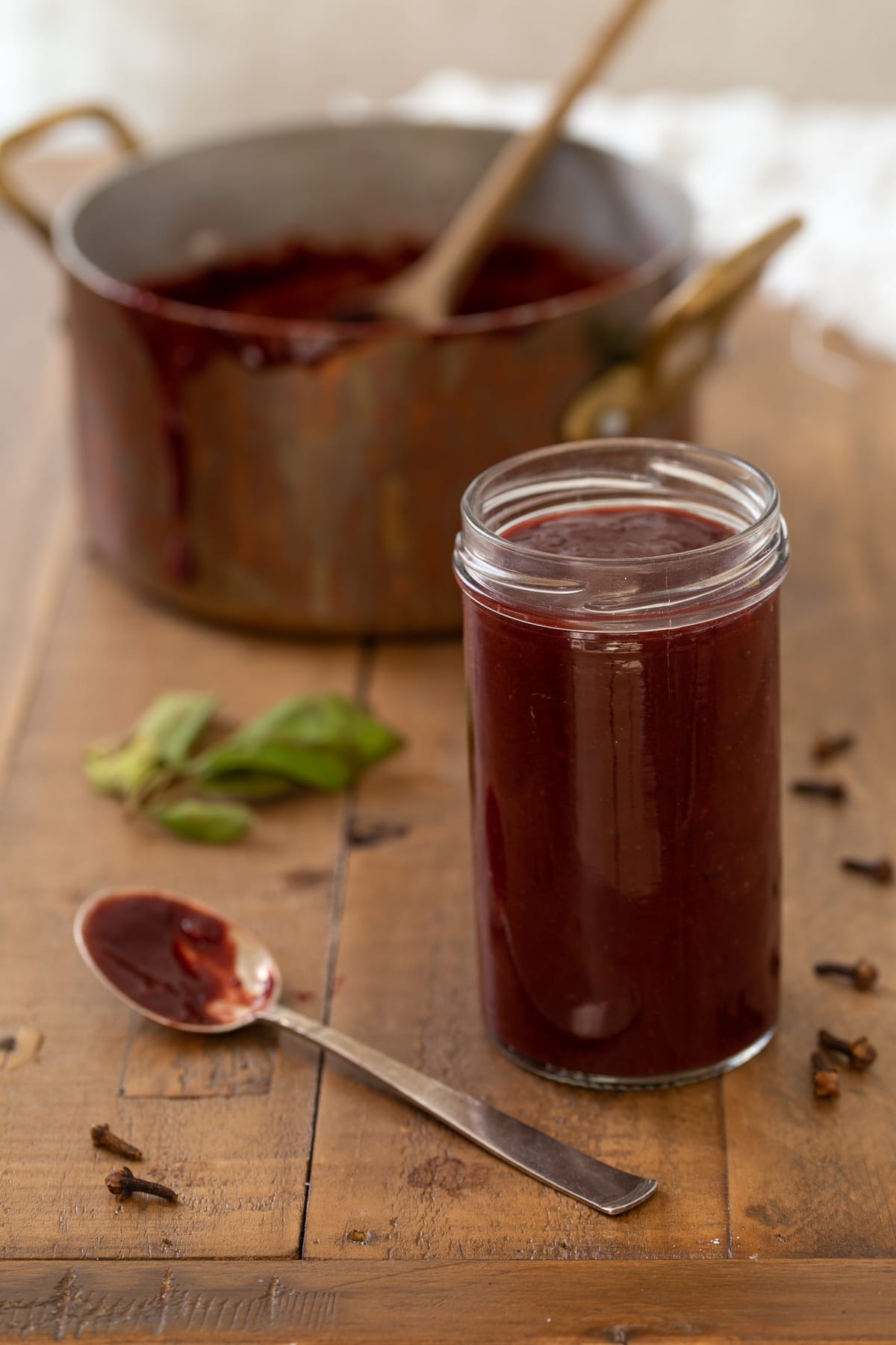 A small jar of jam, the rest in a pot in the background.
