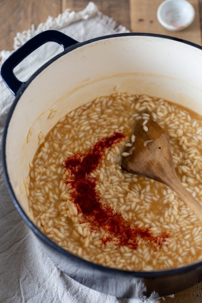 The addition of powdered saffron to risotto.