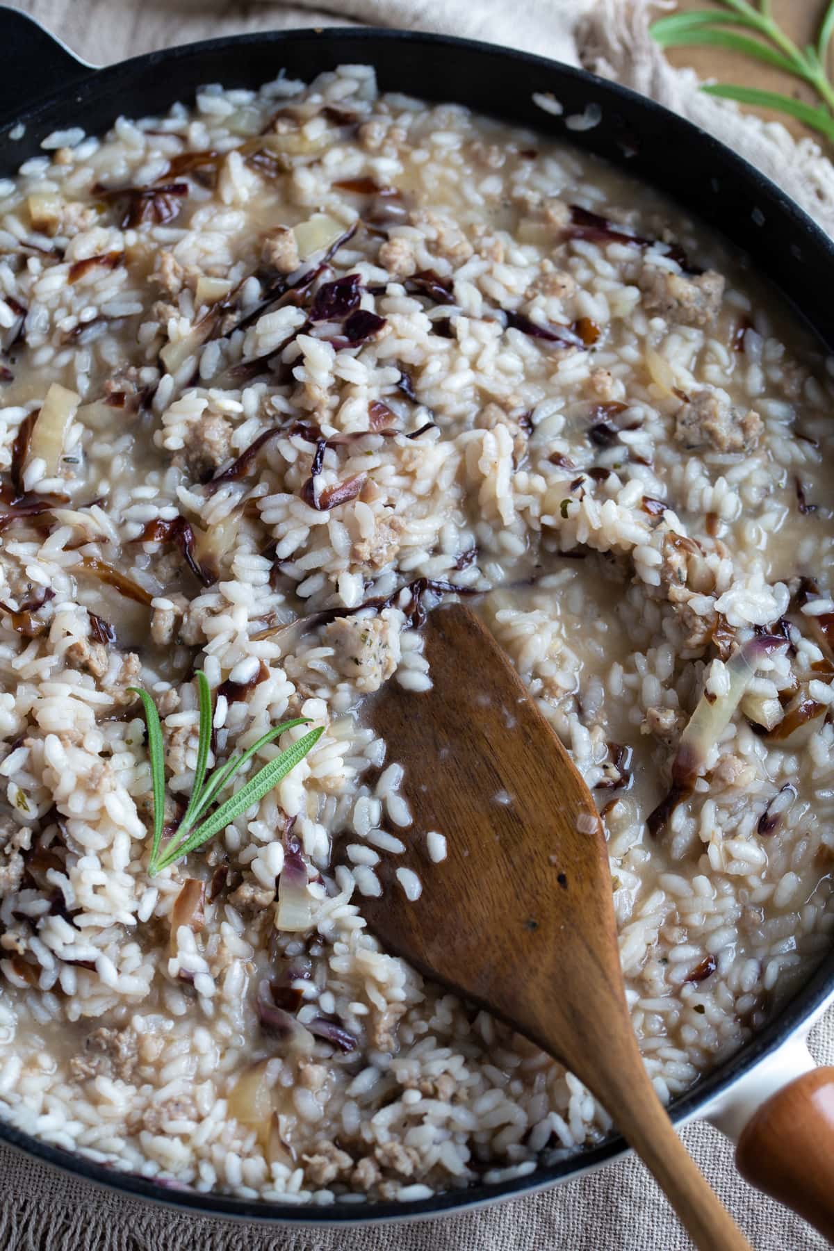 Closeup of sausage risotto in a skillet.