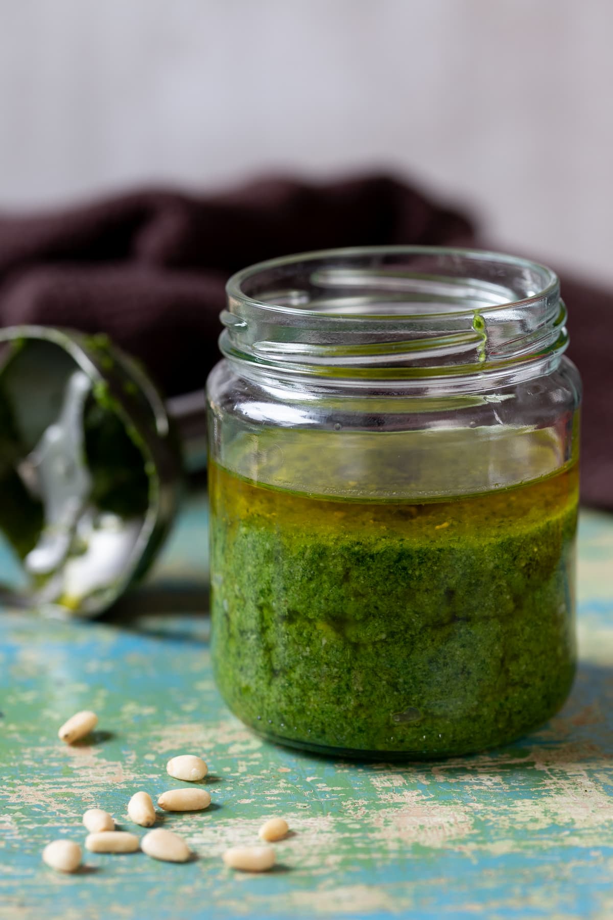 Basil pesto in a jar topped with olive oil to keep fresh.