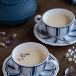 Two portions of earl grey panna cotta in tea cups.