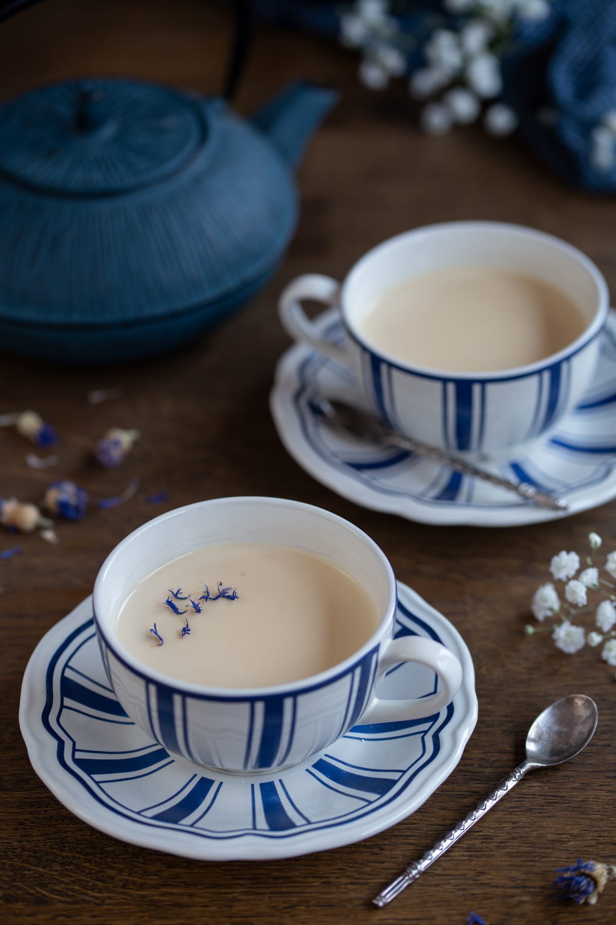 Two portions of earl grey panna cotta in tea cups.