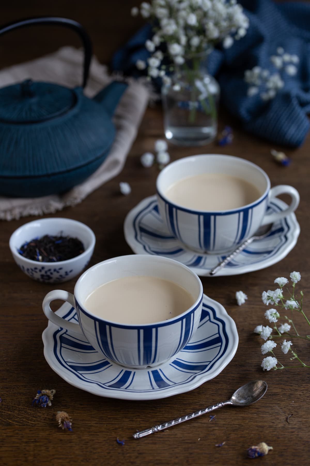 Two portions of earl grey panna cotta in tea cups.
