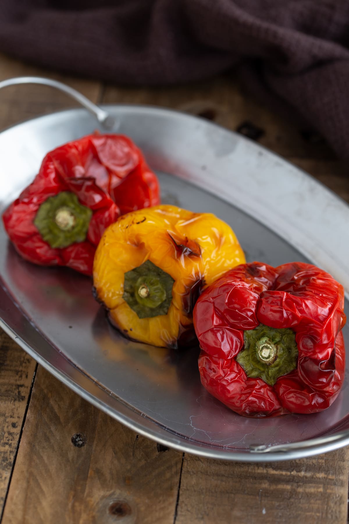 Oven-roasted bell peppers on a metal serving plate.