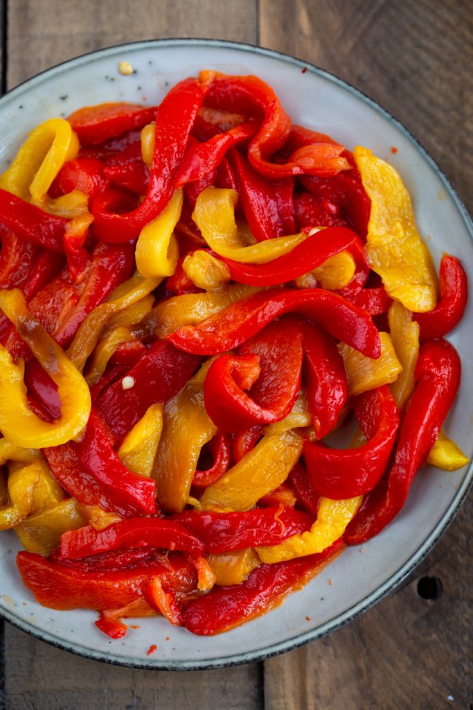 Sliced red and yellow roasted bell pepper.