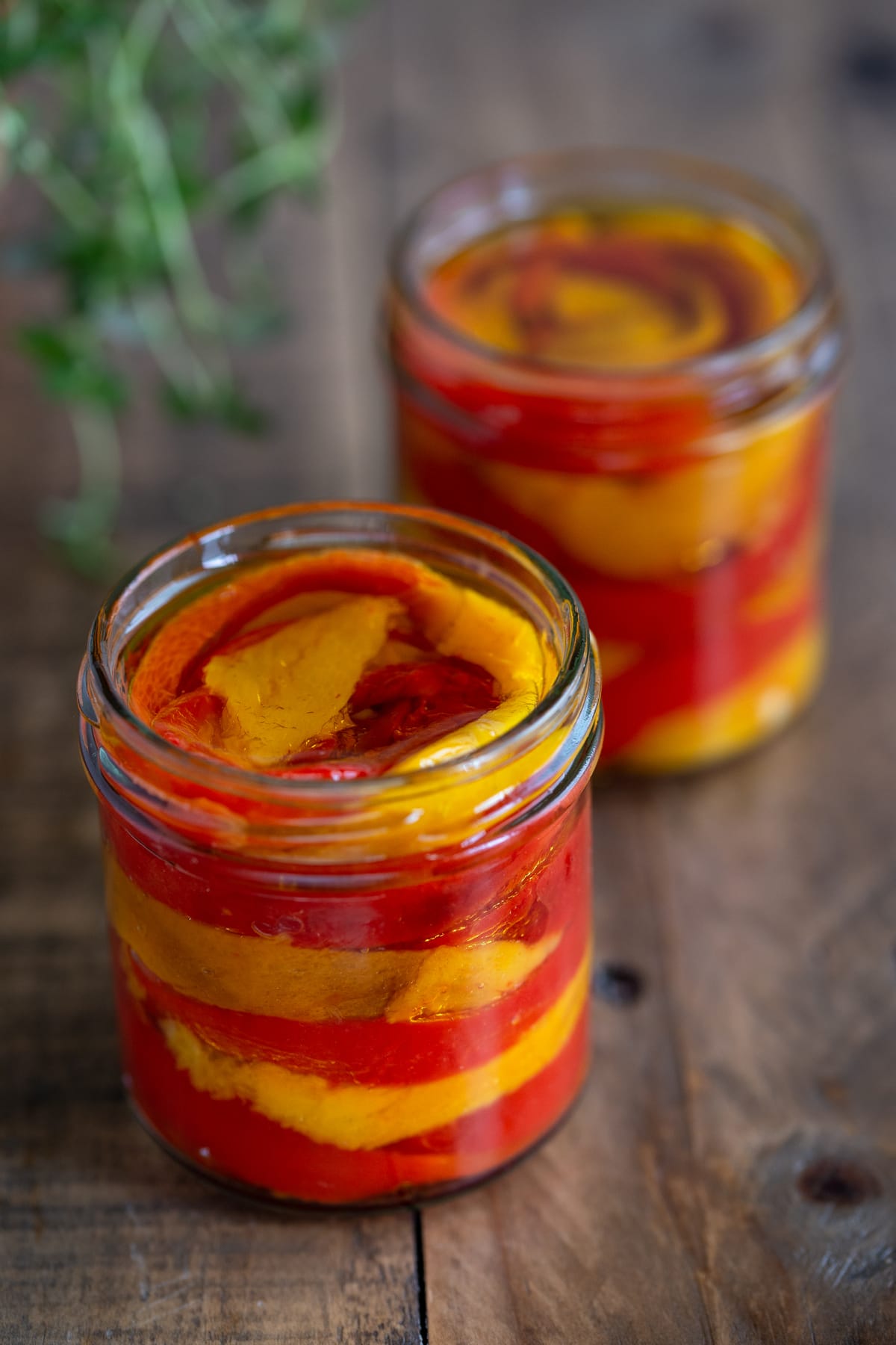 Two jars of sliced roasted bell peppers in oil.