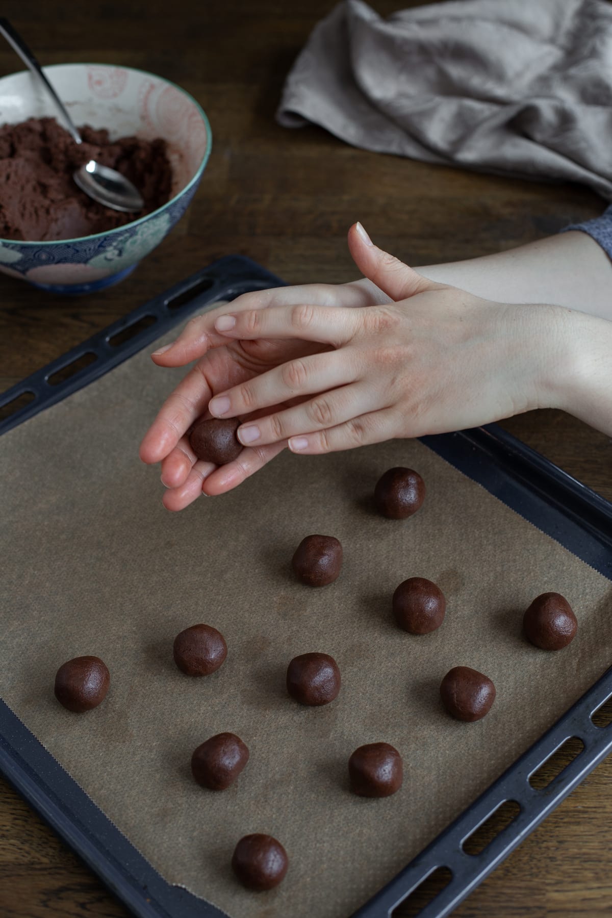 Rolling small balls of batter.