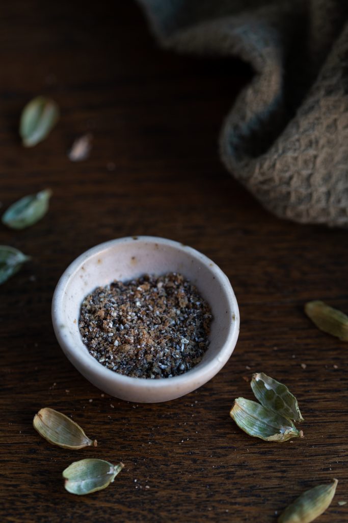 Coarsely ground cardamom in a tiny bowl.