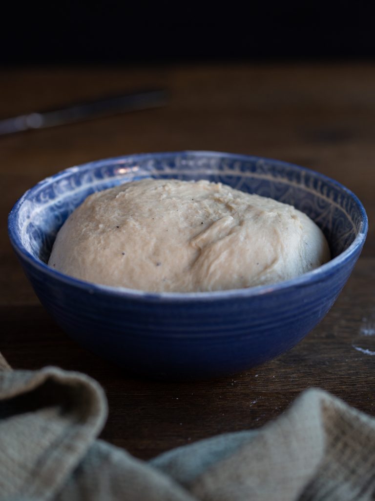 Kanelbulle dough rising in a bowl.