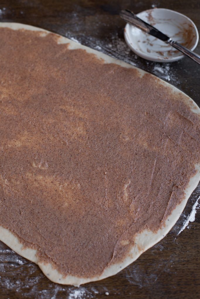 Cinnamon mixture spread over dough.