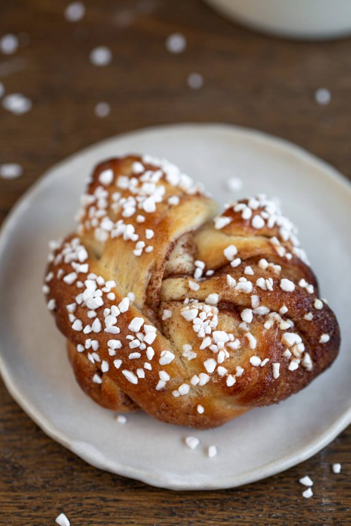 Swedish cinnamon bun on a small white plate.