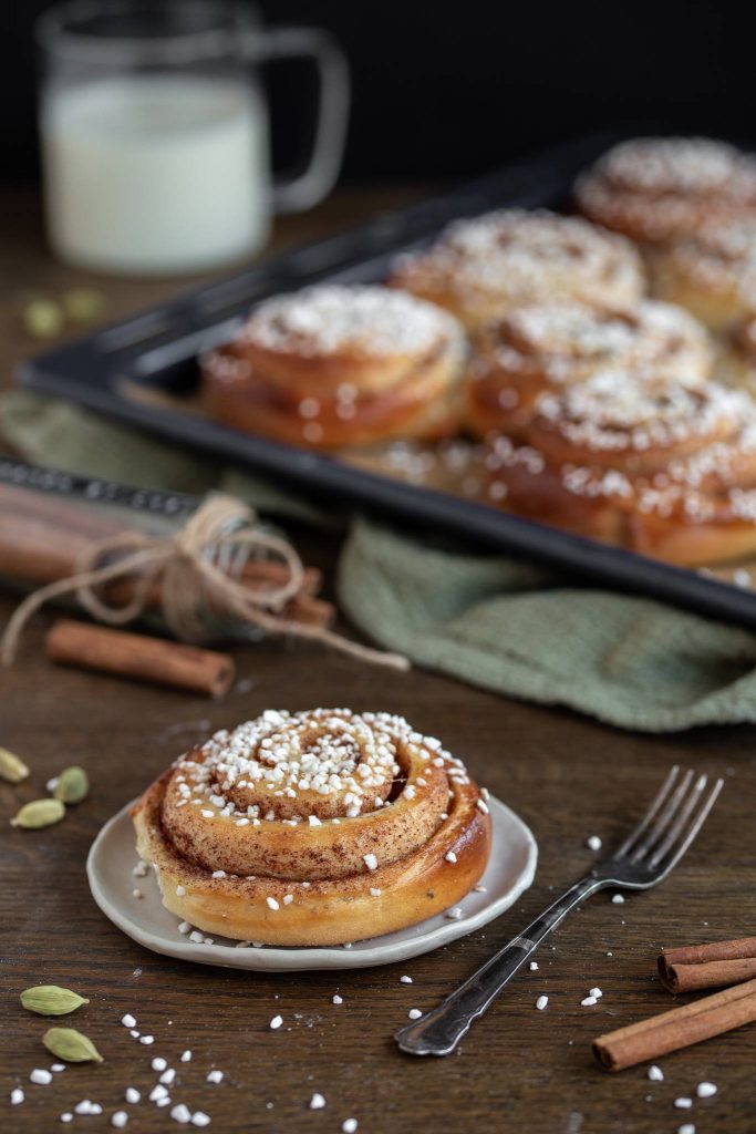 Swedish cinnamon bun on a small white plate.