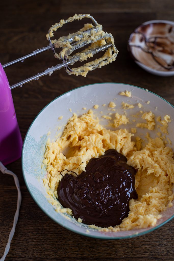 Adding melted chocolate to cake batter.