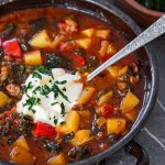 Meat soup topped with creme fraiche and cavolo nero chips.