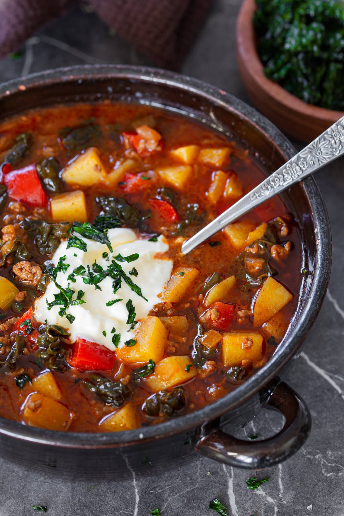 Meat soup topped with creme fraiche and cavolo nero chips.