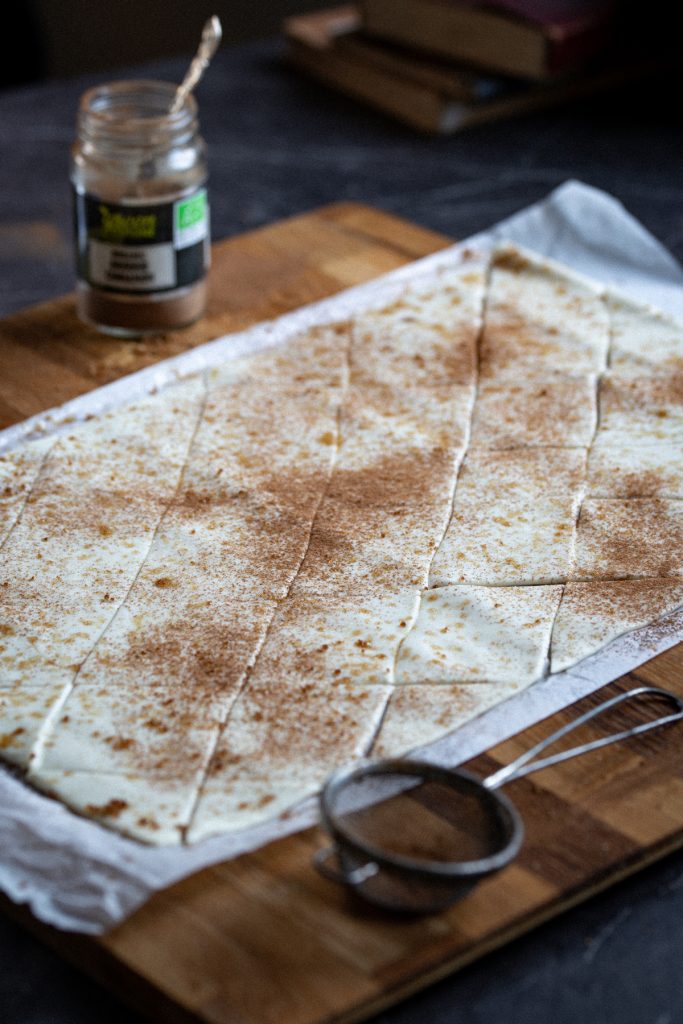 Puff pastry sheet dusted with brown sugar and cinnamon.