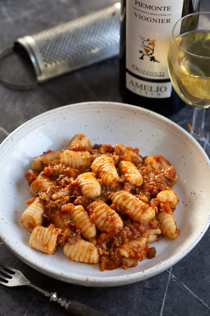 A portion of gnocchi with hazelnut mushroom ragu.