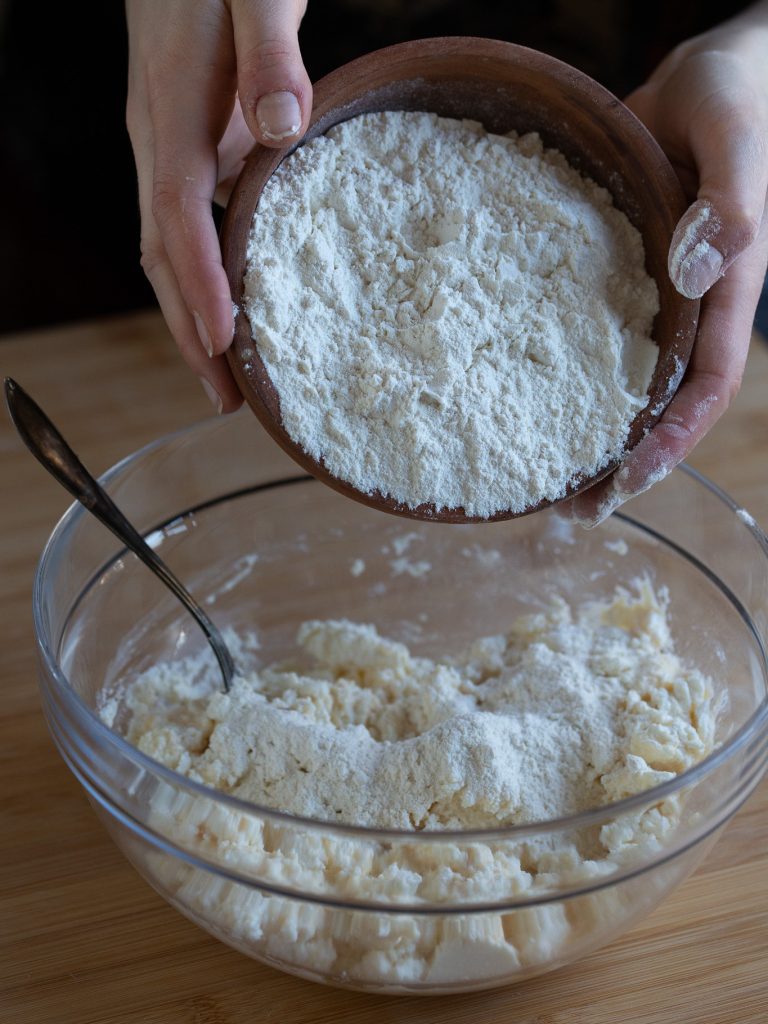Adding flour to ricotta mixture.