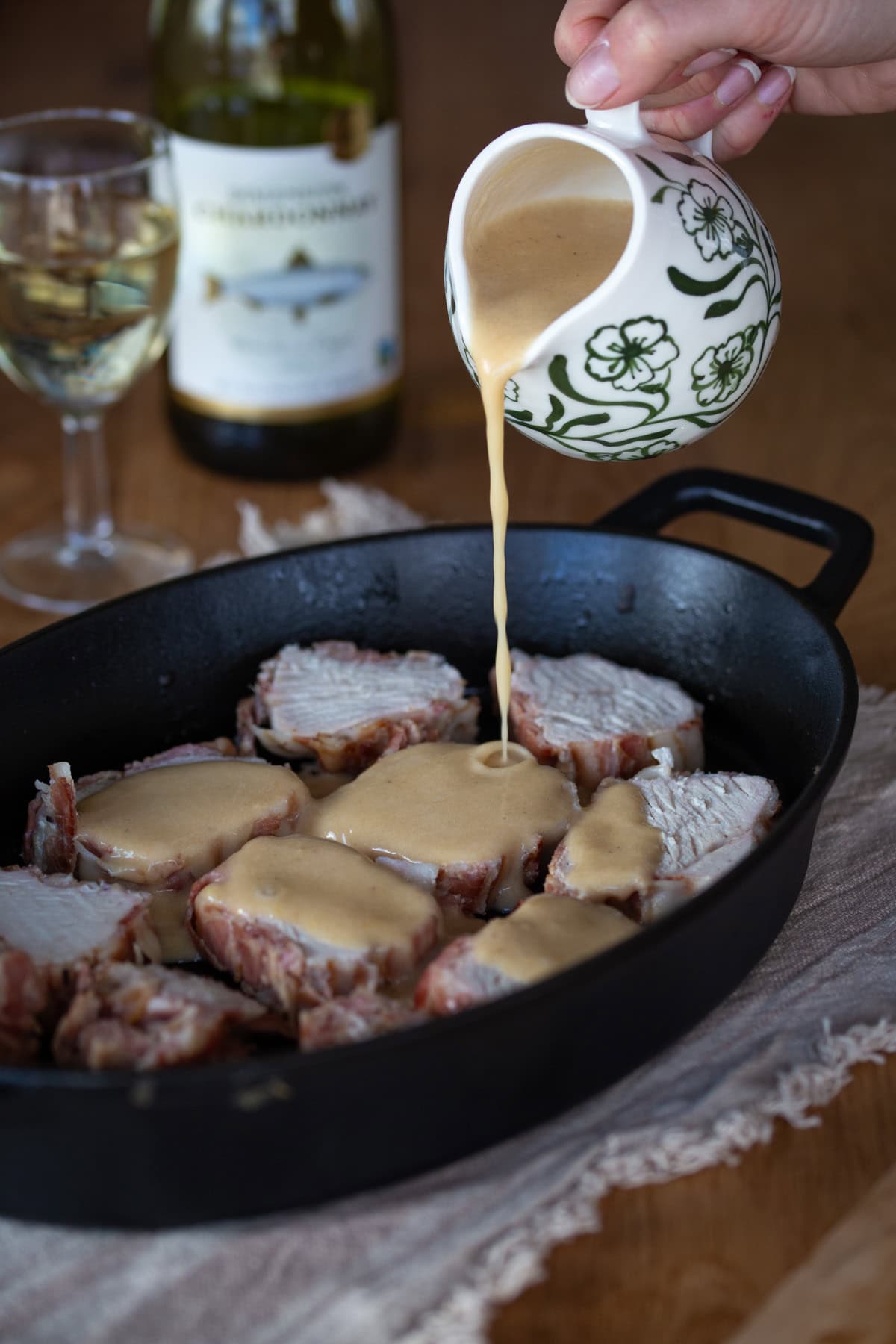 Pouring gravy over roast meat.