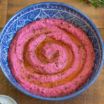 Beet hummus in a blue mandala bowl.